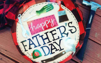 Happy father's day balloon next to tools on a table