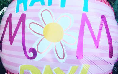 Close up of a pink mum balloon with a daffodil pattern