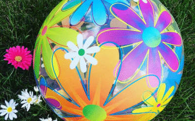Flower party bubble balloon on a grass background